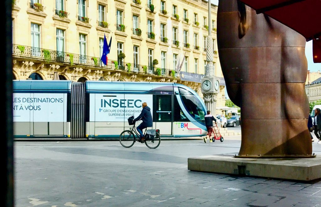 streetcar with INSEEC logo in Bordeaux in front of the Grand Theatre